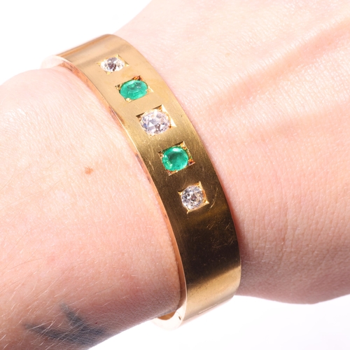 1128 - An Antique Victorian 18ct gold five stone emerald and diamond hinged bangle, circa 1860, square set ... 