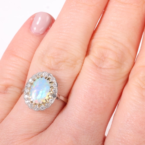 1131 - An Antique platinum opal and diamond cluster ring, re-hallmarked for London 2016, claw set with 0.65... 