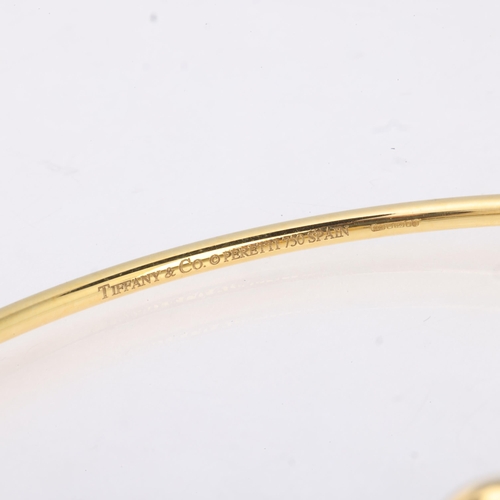 1147 - TIFFANY & CO - an 18ct gold Double Open Heart bangle, designed by Elsa Peretti, London 2004, signed ... 