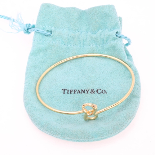 1147 - TIFFANY & CO - an 18ct gold Double Open Heart bangle, designed by Elsa Peretti, London 2004, signed ... 