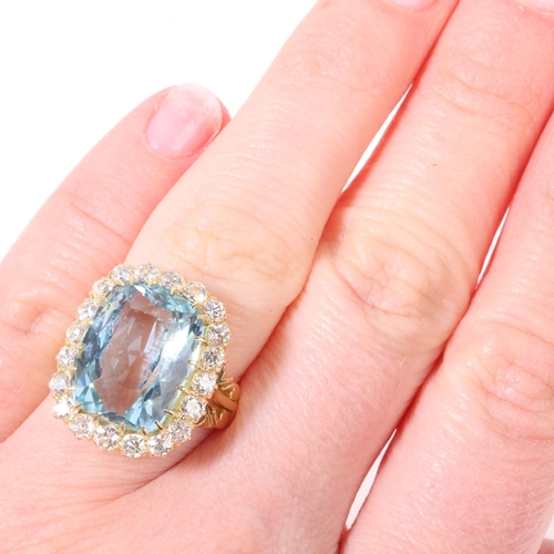 1148 - An 18ct gold aquamarine and diamond cluster ring, set with 10ct cushion-cut aquamarine surrounded by... 