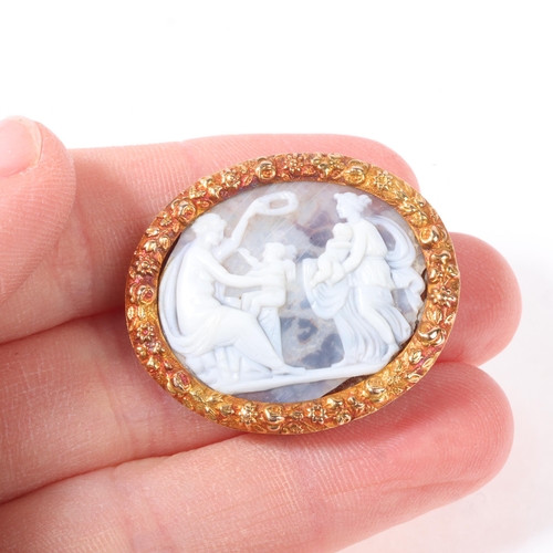 1149 - An Antique hardstone cameo brooch, the oval panel relief carved depicting female figures with cherub... 