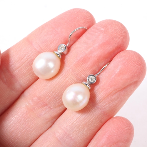 1169 - A pair of 18ct white gold whole pearl and diamond earrings, with shepherd hook fittings, 24mm, 3.9g