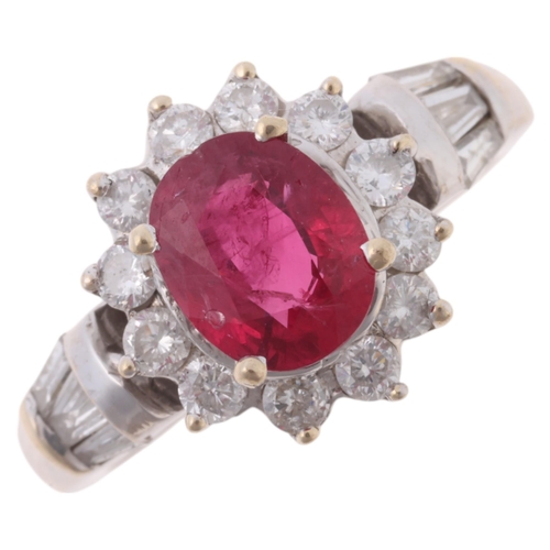 1170 - An 18ct white gold ruby and diamond flowerhead cluster ring, claw set with 1.1ct oval mixed-cut ruby... 