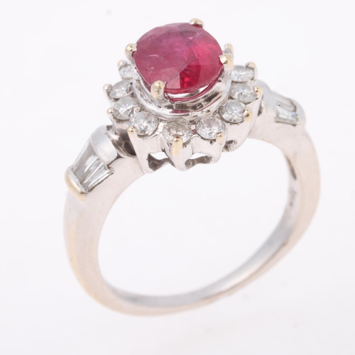 1170 - An 18ct white gold ruby and diamond flowerhead cluster ring, claw set with 1.1ct oval mixed-cut ruby... 