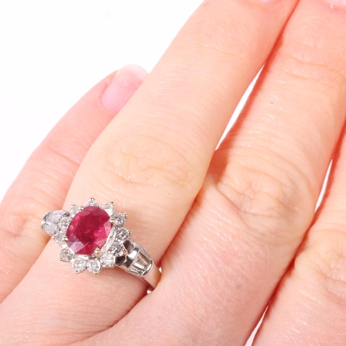 1170 - An 18ct white gold ruby and diamond flowerhead cluster ring, claw set with 1.1ct oval mixed-cut ruby... 