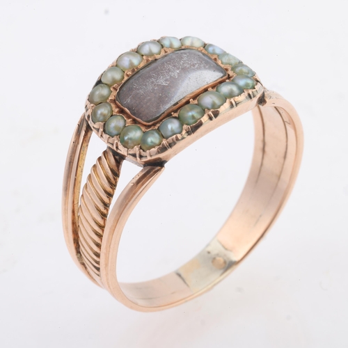 1173 - An Antique Georgian hairwork split pearl mourning ring, the oval panel with central convex glazed co... 