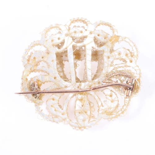 1176 - An Antique Georgian Regency natural seed pearl and mother-of-pearl openwork brooch, circa 1830, mode... 