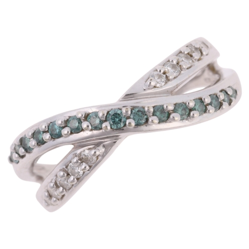 1213 - A 9ct white gold blue diamond and diamond crossover band ring, by QVC, Birmingham 2003, claw set wit... 