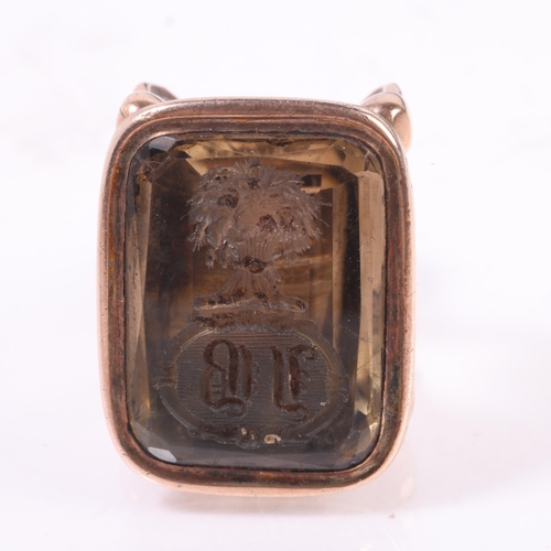 1226 - An Antique Victorian smoky quartz seal fob, the foil-back smoky quartz intaglio carved with cartouch... 