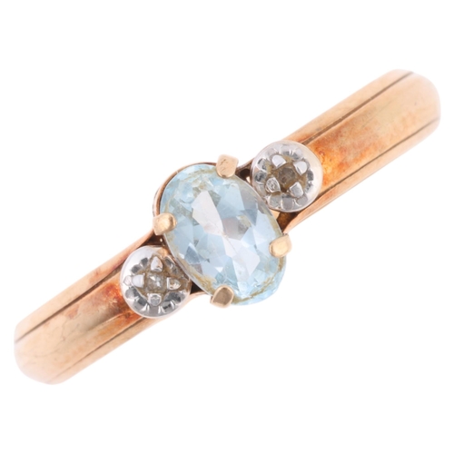 1268 - A 9ct gold three stone blue topaz and diamond ring, claw set with oval mixed-cut topaz and single-cu... 