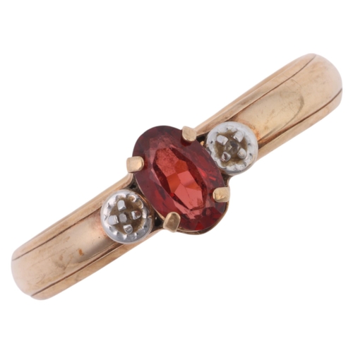 1271 - A 9ct gold three stone garnet and diamond ring, claw set with oval mixed-cut garnet and single-cut d... 