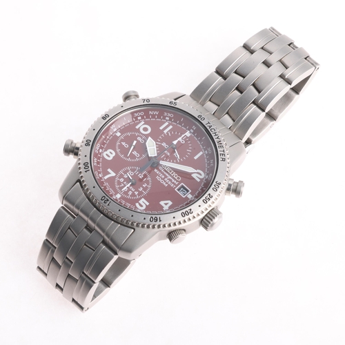 1035 - SEIKO - a stainless steel Pilot quartz chronograph calendar bracelet watch, ref. 7T32-7E50, red dial... 