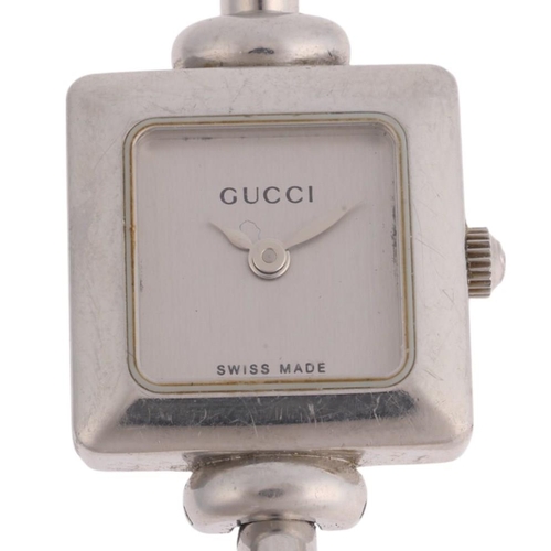 1068 - GUCCI - a lady's stainless steel 1900L quartz bangle watch, silvered dial with leaf hands, square ca... 