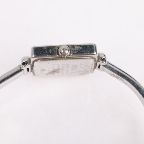 1068 - GUCCI - a lady's stainless steel 1900L quartz bangle watch, silvered dial with leaf hands, square ca... 