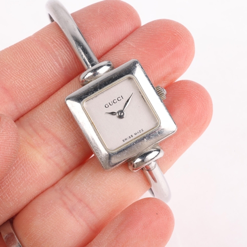 1068 - GUCCI - a lady's stainless steel 1900L quartz bangle watch, silvered dial with leaf hands, square ca... 