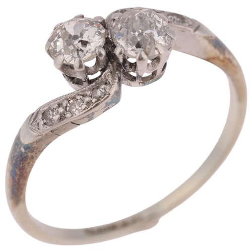 1113 - An Art Deco 18ct white gold two-stone diamond crossover ring, circa 1930, claw set with 2 round tran... 