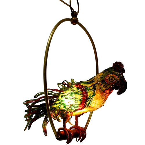 515 - A Venetian Murano glass beadwork Parrot lamp on a brass perch. Length 39cm from hanging loop to perc... 