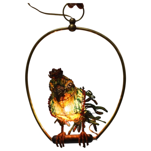 515 - A Venetian Murano glass beadwork Parrot lamp on a brass perch. Length 39cm from hanging loop to perc... 