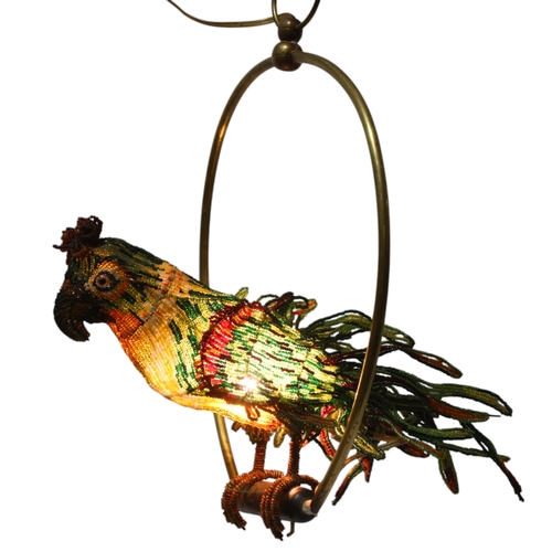 515 - A Venetian Murano glass beadwork Parrot lamp on a brass perch. Length 39cm from hanging loop to perc... 