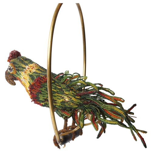 515 - A Venetian Murano glass beadwork Parrot lamp on a brass perch. Length 39cm from hanging loop to perc... 