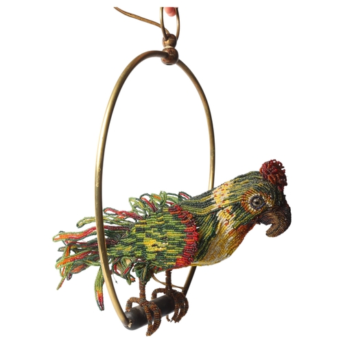 515 - A Venetian Murano glass beadwork Parrot lamp on a brass perch. Length 39cm from hanging loop to perc... 