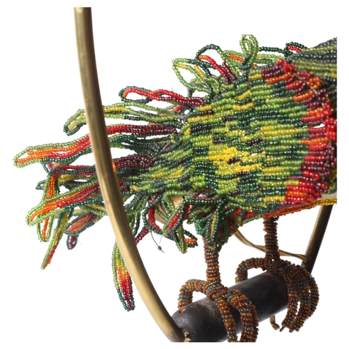 515 - A Venetian Murano glass beadwork Parrot lamp on a brass perch. Length 39cm from hanging loop to perc... 