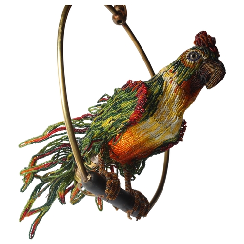 515 - A Venetian Murano glass beadwork Parrot lamp on a brass perch. Length 39cm from hanging loop to perc... 