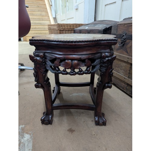 2213 - A Chinese hardwood Jardinière stand, with inset marble top and all-over carved and pierced decoratio... 