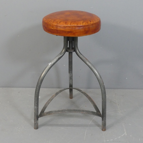 2143 - An industrial style leather upholstered stool on tubular metal tripod base.