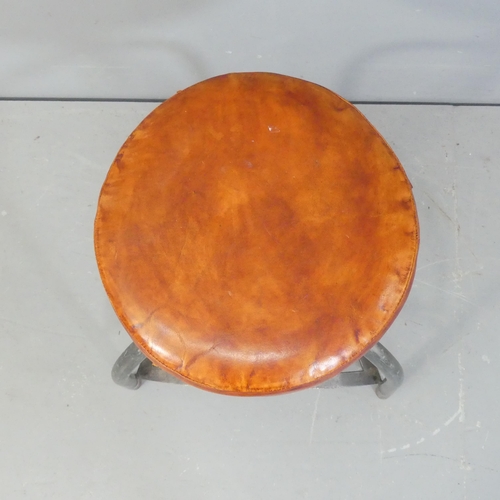 2143 - An industrial style leather upholstered stool on tubular metal tripod base.