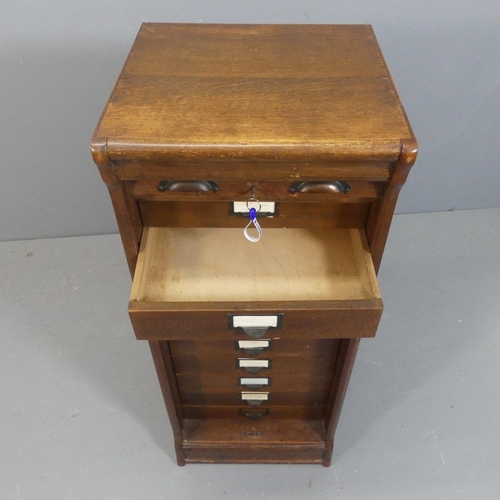 2176 - A Victorian oak tambour front filing chest of ten drawers. Width 44cm, height 109cm, depth 42cm.