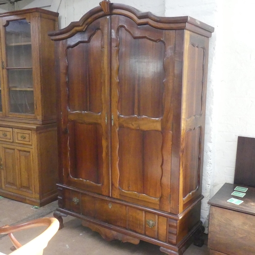 2198 - A South African stinkwood Dutch style armoire. Width 130cm, height 200cm, depth 55cm.