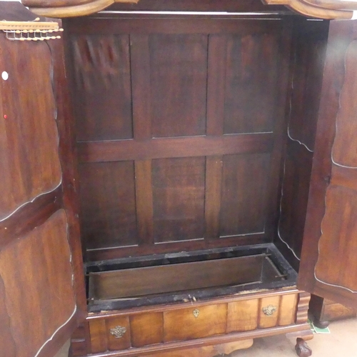 2198 - A South African stinkwood Dutch style armoire. Width 130cm, height 200cm, depth 55cm.