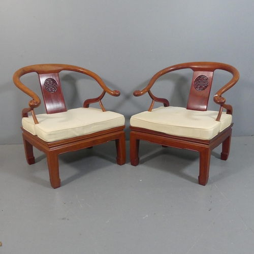 2204 - A pair of modern Chinese hardwood Ming style chairs with scrolled horseshoe arms and carved decorati... 