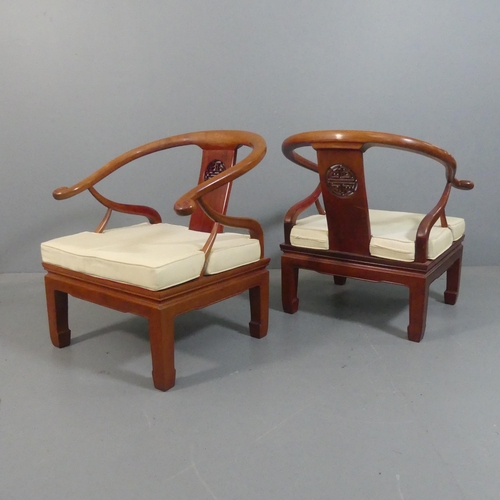 2204 - A pair of modern Chinese hardwood Ming style chairs with scrolled horseshoe arms and carved decorati... 