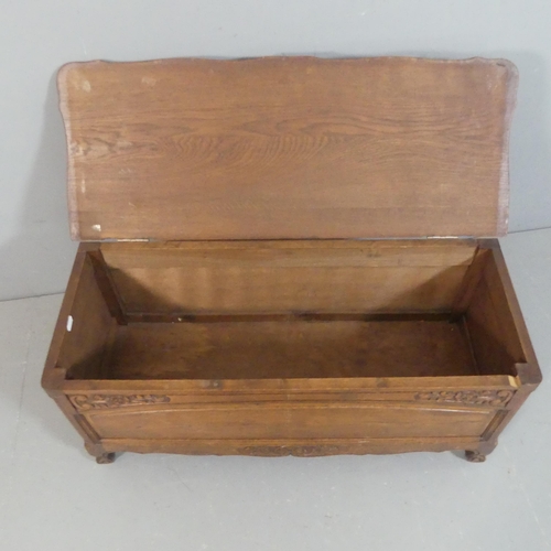 2205 - A French oak blanket box, with carved and panelled decoration. Width 98cm, height 46cm, depth 39cm.