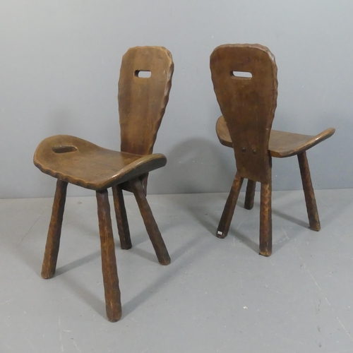 2211 - A pair of mid-century French brutalist wooden alpine chairs, the shaped seats with integral handles.