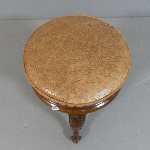 2222 - A Victorian walnut and leather upholstered stool with carved decoration. Height 46cm.