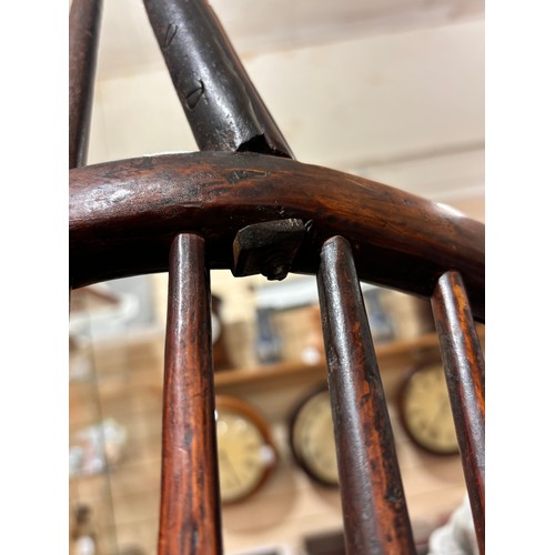 499 - An early 19th century yew wood bow arm Windsor chair, with Prince of Wales Feather design splat and ... 