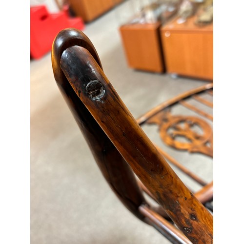 499 - An early 19th century yew wood bow arm Windsor chair, with Prince of Wales Feather design splat and ... 