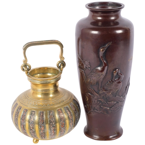 124 - A 19th century Indian brass and copper swing-handled censer, and a Japanese patinated bronze crane v... 