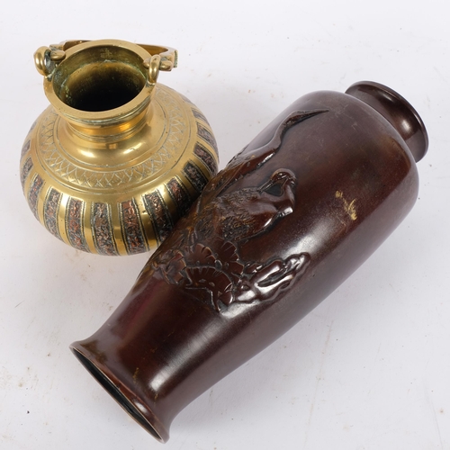 124 - A 19th century Indian brass and copper swing-handled censer, and a Japanese patinated bronze crane v... 