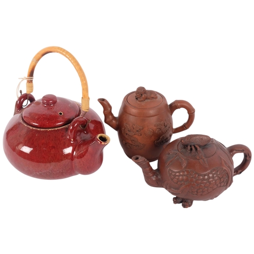 132 - 2 Chinese Yixing style clay teapots, and a Chinese redware teapot (3)
