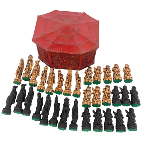 136 - A set of Chinese resin chessmen, in red resin pagoda box, W26cm