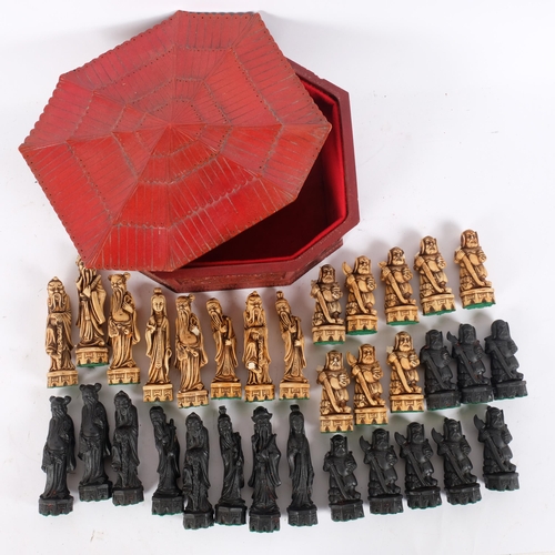 136 - A set of Chinese resin chessmen, in red resin pagoda box, W26cm
