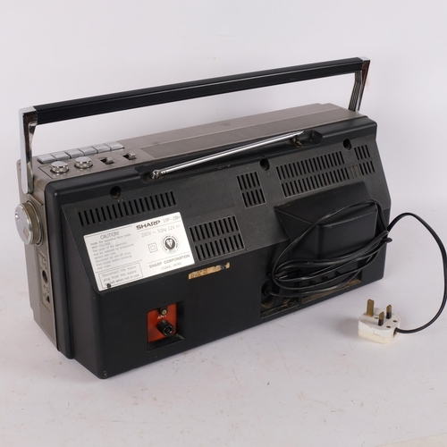 174 - A Vintage Sharp portable TV, radio and tape cassette player, with mains cable