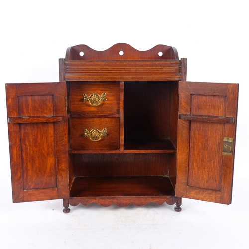 36 - A Victorian oak smoker's cabinet, with relief carved panelled doors, W32cm, H45cm