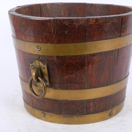 40 - A brass-mounted oak barrel type jardiniere, circa 1900, with brass ring handles, rim diameter 31cm, ... 