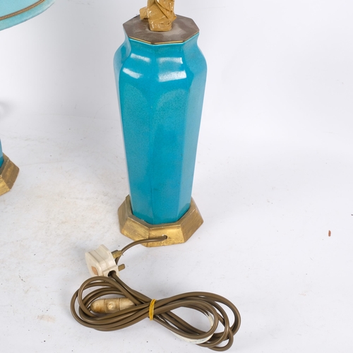 50 - A pair of early 20th century turquoise glaze pottery table lamps, on gilded bases, with turquoise sh... 